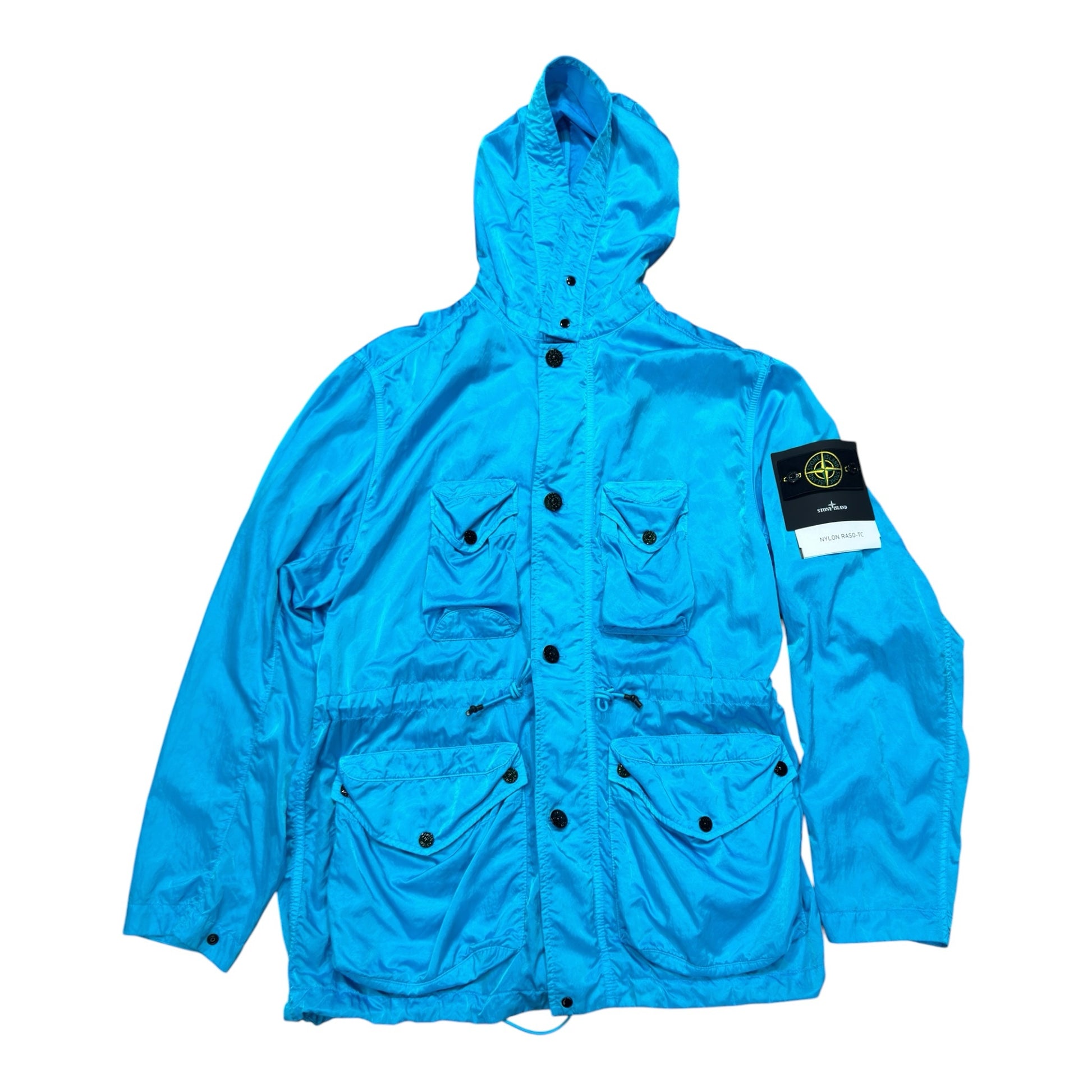 Urban Saints Stone Island blue nylon satin hooded jacket with four front pockets and signature sleeve compass patch.