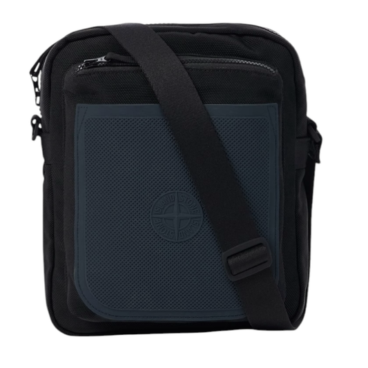 Urban Saints black nylon crossbody bag with navy blue textured panel and embossed Stone Island logo. Zip pockets and adjustable strap.